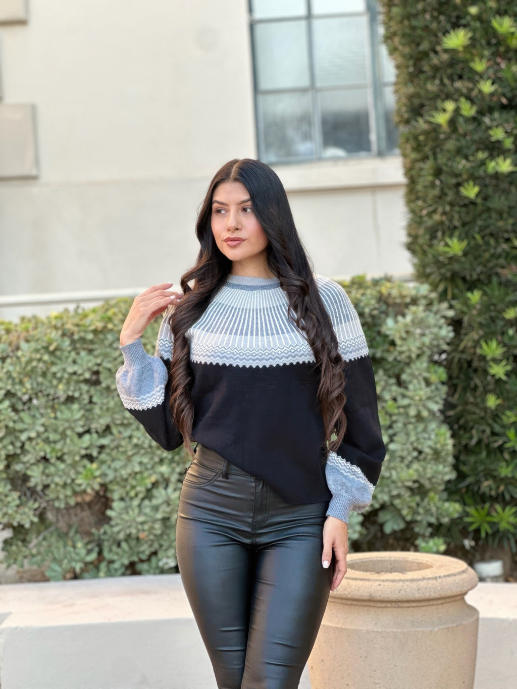 Front view sweater with light blue patterned yoke and cuffs, dark knit body