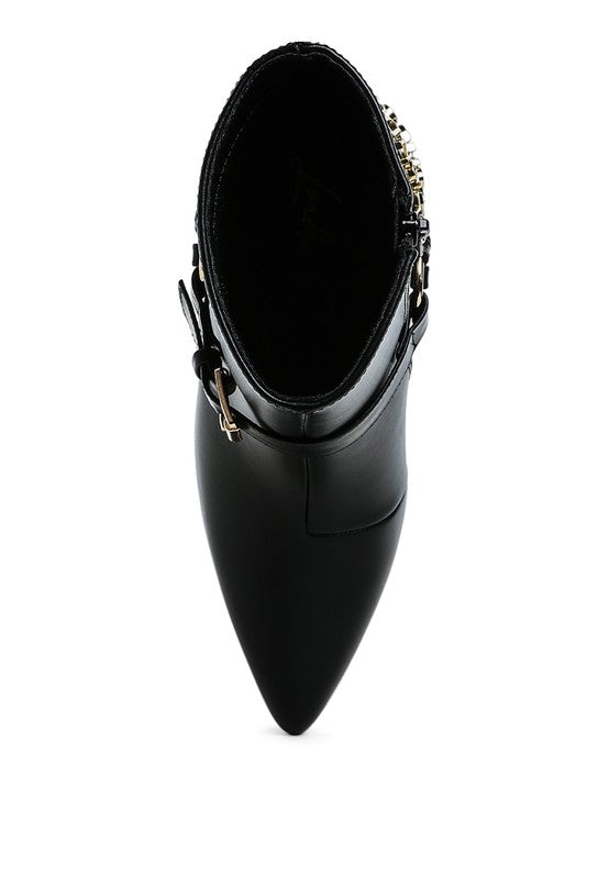 Black stiletto ankle boot viewed from the heel, showing pointed toe and strap hardware