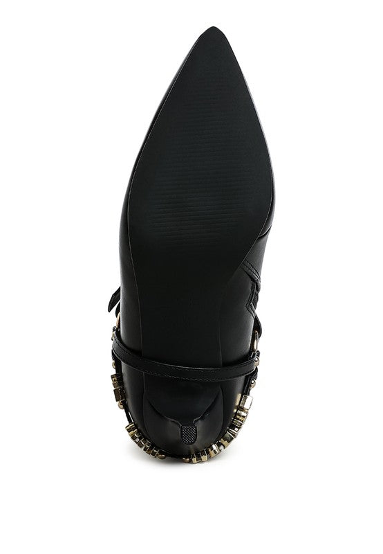 Black stiletto ankle boot with curved toe, front harness strap, and gold-tone edge trim