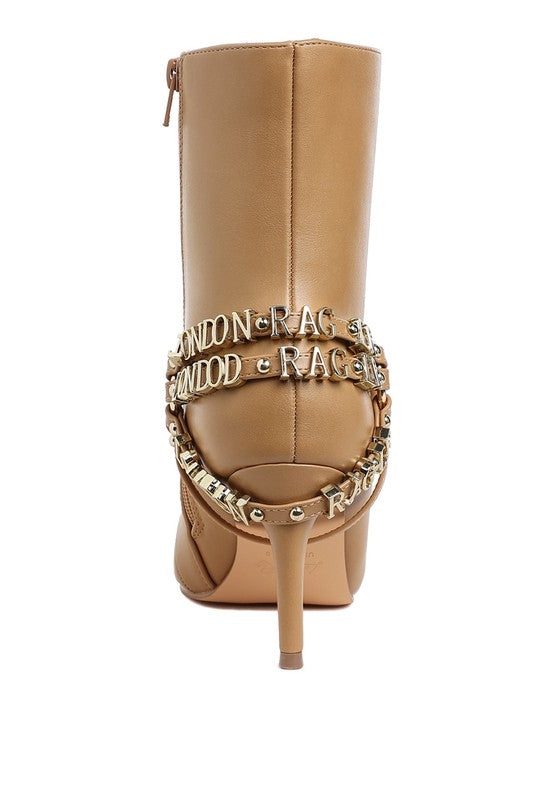 Beige stiletto ankle boot with harness strap and gold-tone chain details