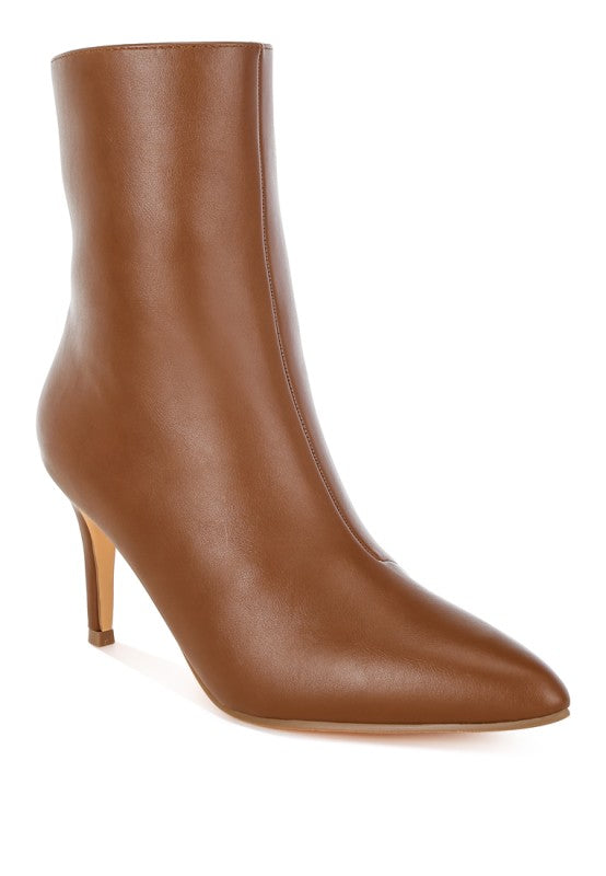 Brown stiletto ankle boot with sleek side profile and harness strap