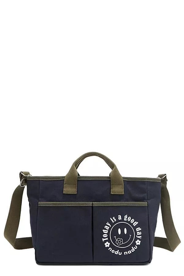 Navy canvas tote bag with shoulder strap, olive handles, and round graphic logo
