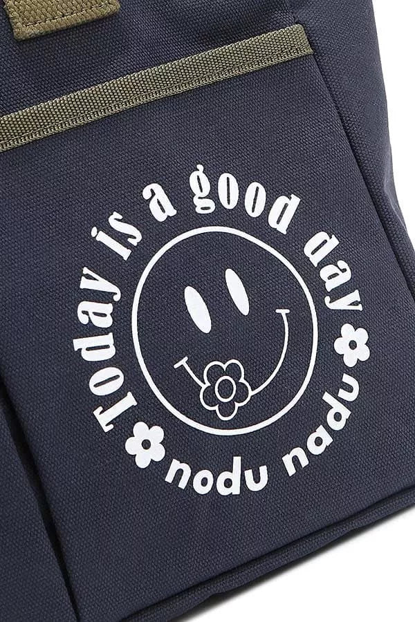 Close-up of navy tote bag graphic logo with smiley face and text