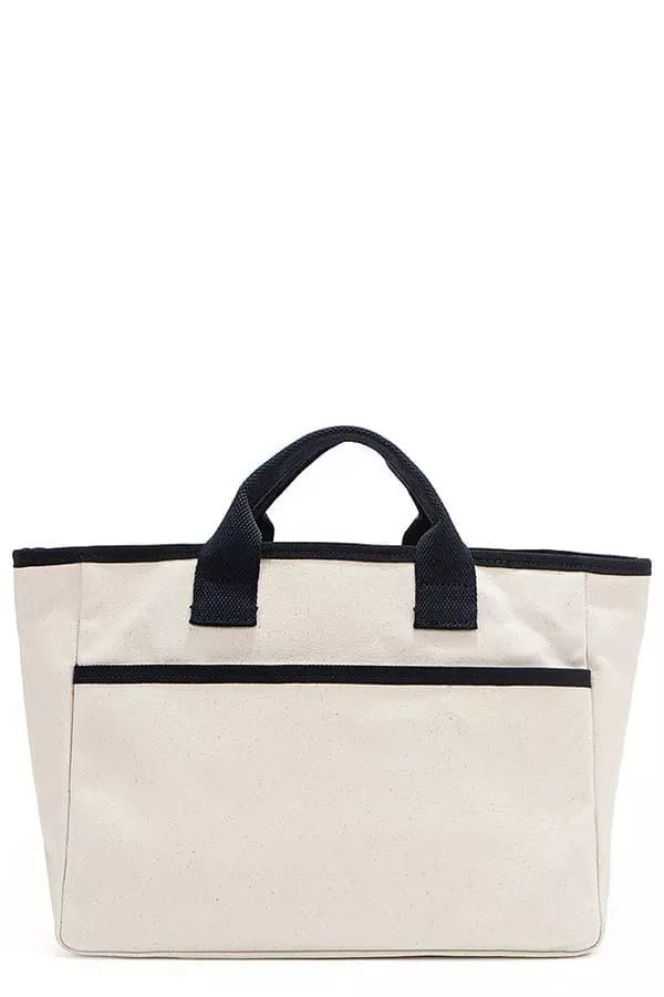 Beige canvas tote bag with black top handles and horizontal front band