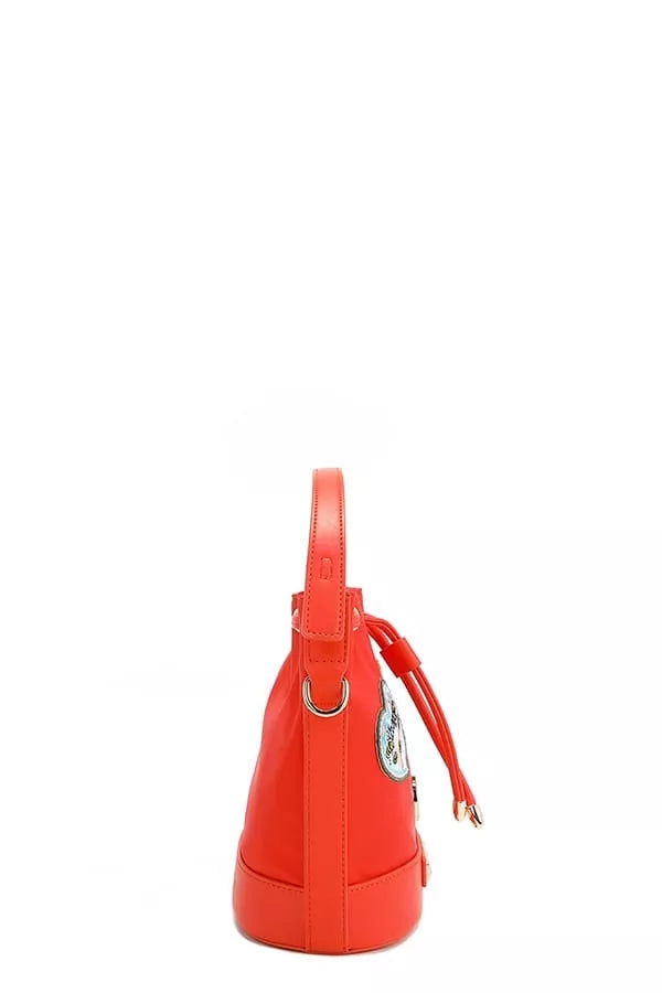 Red bucket bag side profile with loop handle and small zipper pull detail