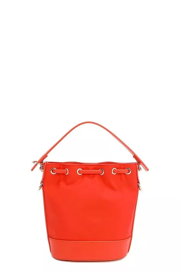 Red bucket bag back view with top grommet rings and metal zipper hardware