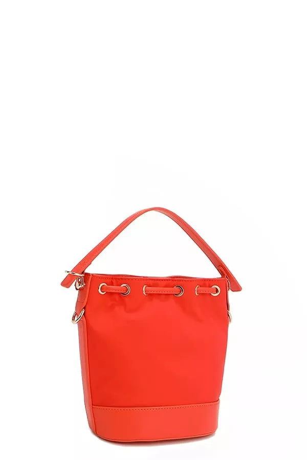 Red bucket bag front view with curved handle and minimal patch-free body