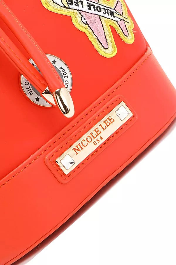 Close-up of red bucket bag front logo patch and star-shaped zipper pull charm