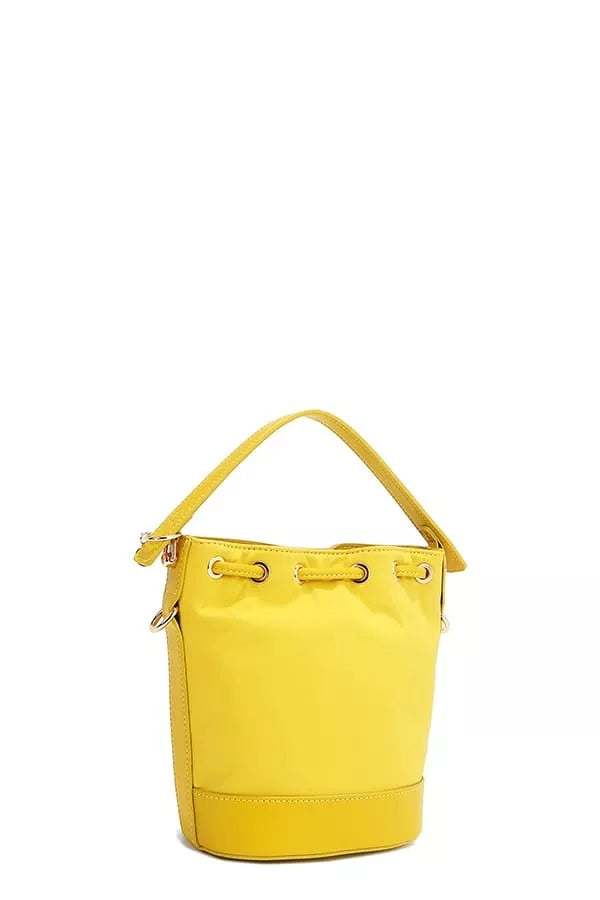 Yellow bucket bag angled view with top handle and zip hardware
