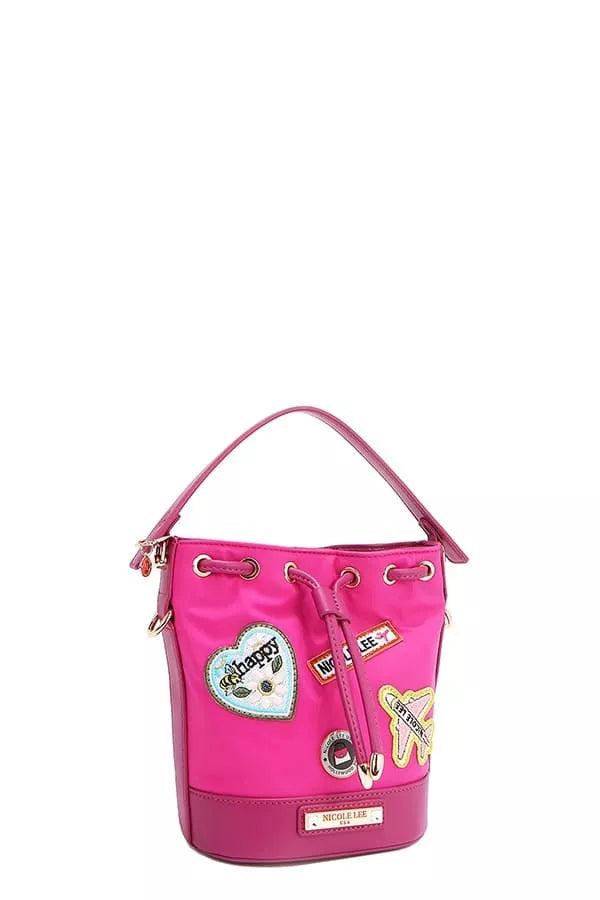 Pink bucket bag side view with hanging straps and patch appliqués
