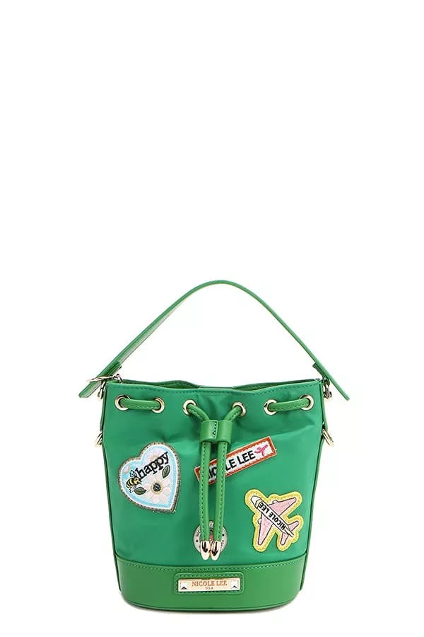 Green bucket bag with drawstring and decorative patch panels on the front.