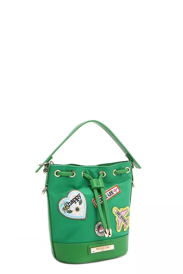 Green bucket bag side view with dangling drawstring and colorful patch detail.