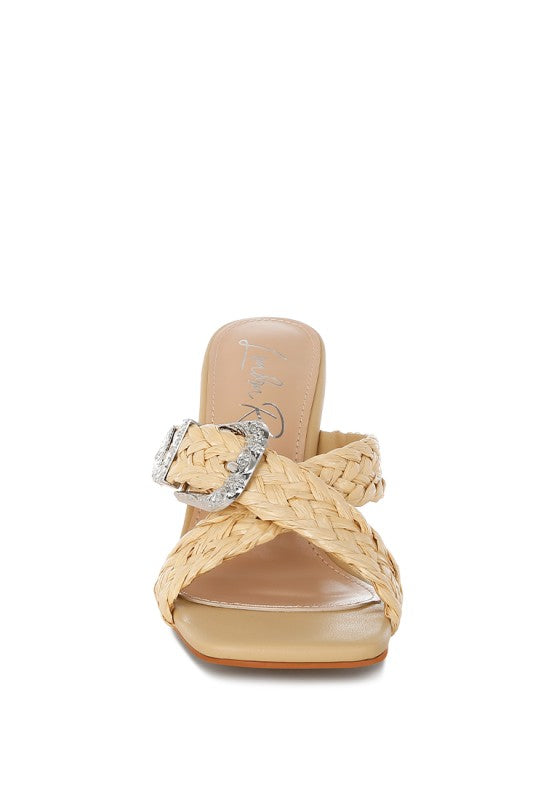 Beige sandal front view with woven braid criss-cross straps and silver-toned buckle