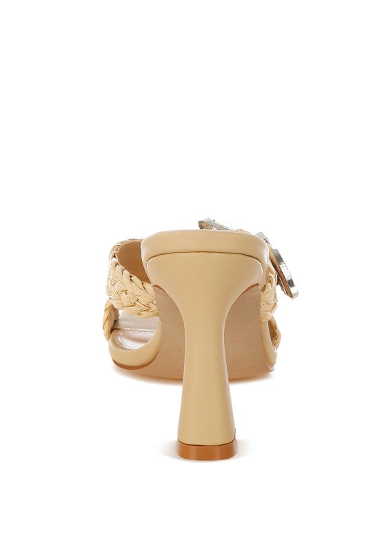 Beige woven mule sandal with criss-cross straps and silver-toned buckle, side view
