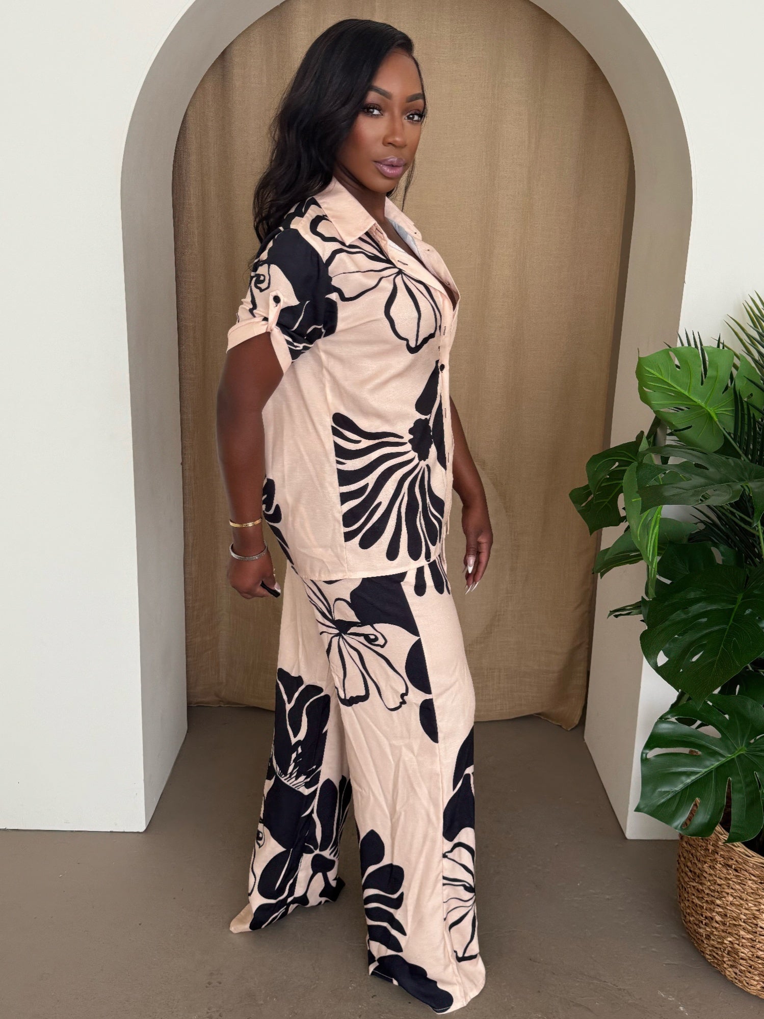 Noir Bloom pants set, cream shirt and matching wide-leg pants with bold black floral print