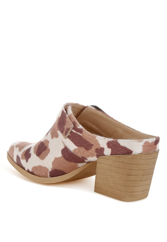 Cow print mules with buckle detail and chunky wooden-look block heel, back angle