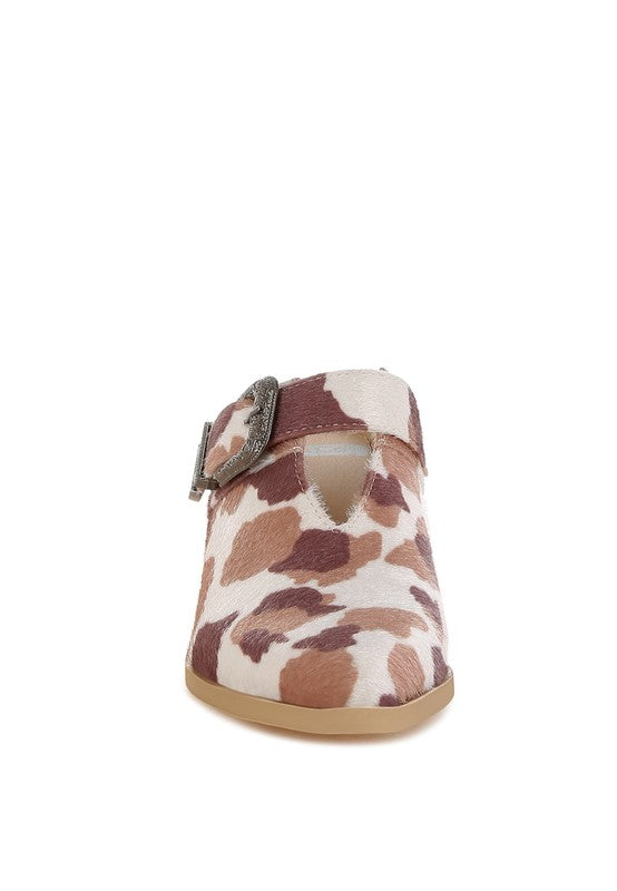 Cow print mule with faux suede buckle strap, rear view showing heel height