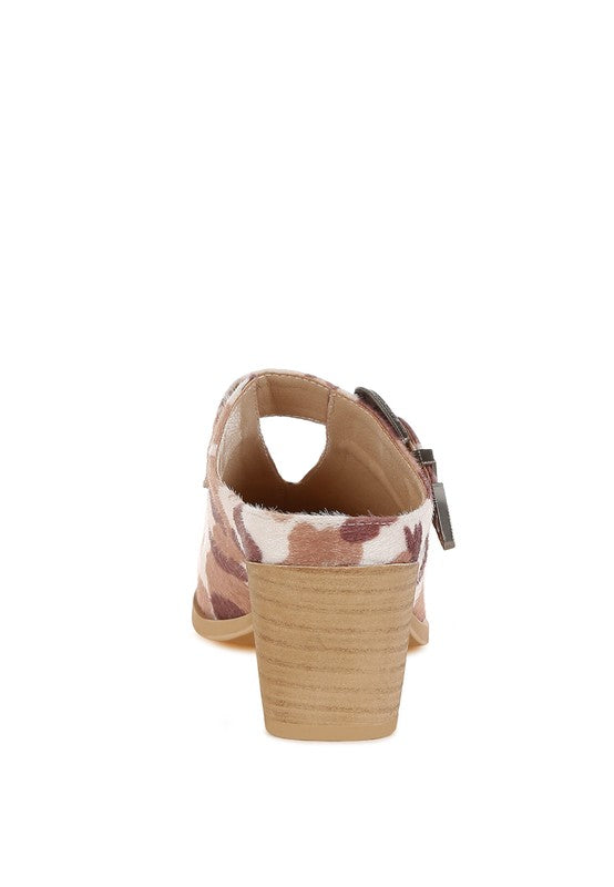 Back of cow print mules with buckle closure and block heel, open collar view