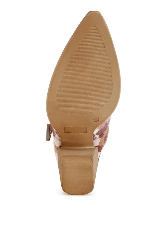 Side view of cow print mule showing smooth faux suede sole and block heel