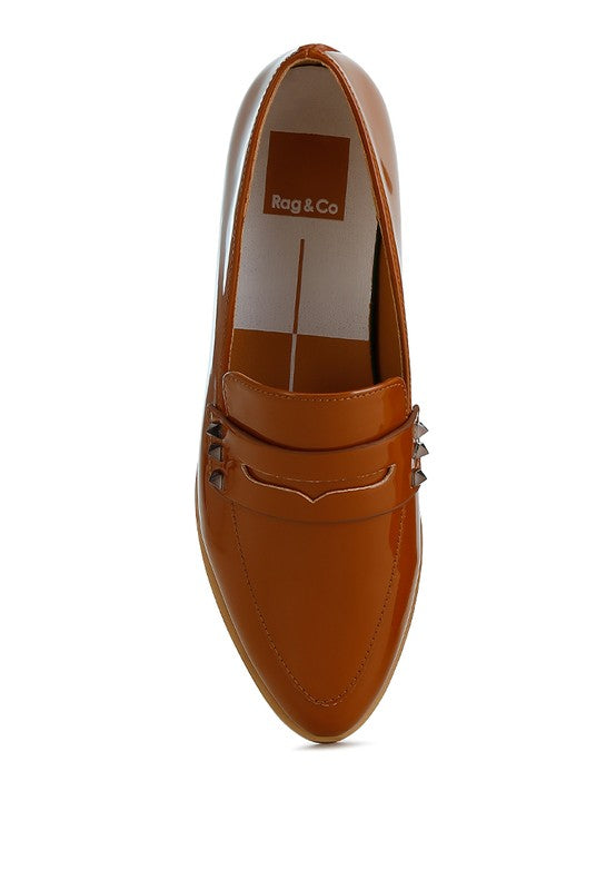 Patent pleather penny loafers in tan brown, closed almond toe and studded strap