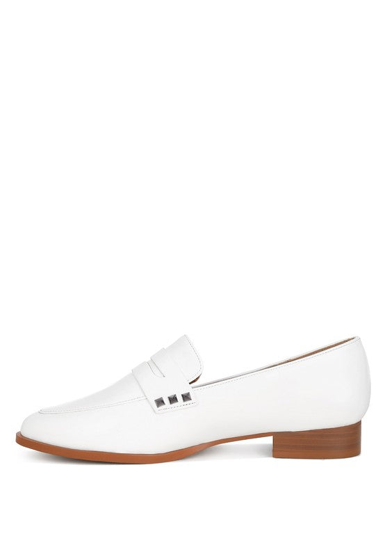 Off-white patent pleather penny loafers, side view with almond toe and metal studs