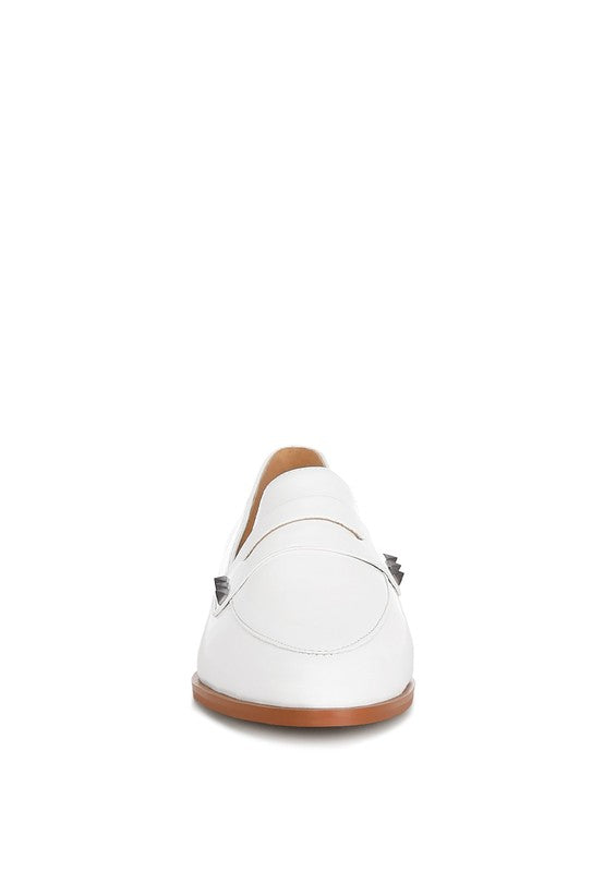Off-white patent pleather penny loafers from the heel side with studded strap