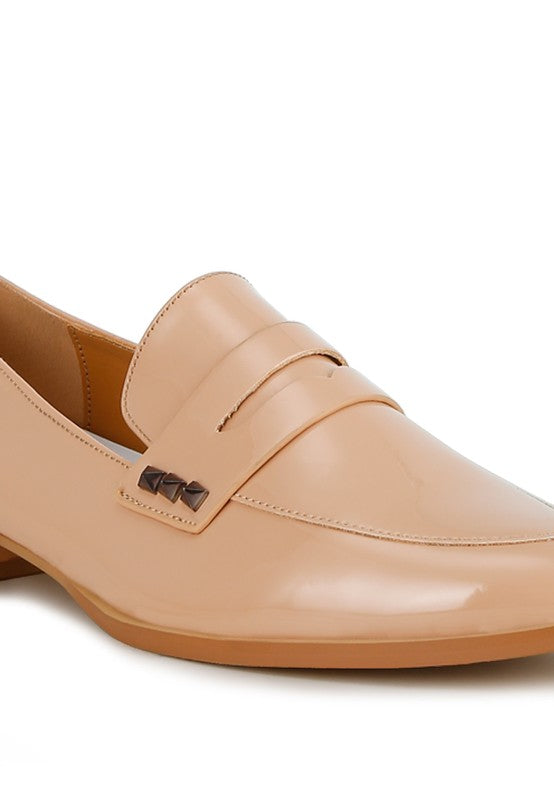 Beige patent pleather penny loafers close-up of strap and penny detail