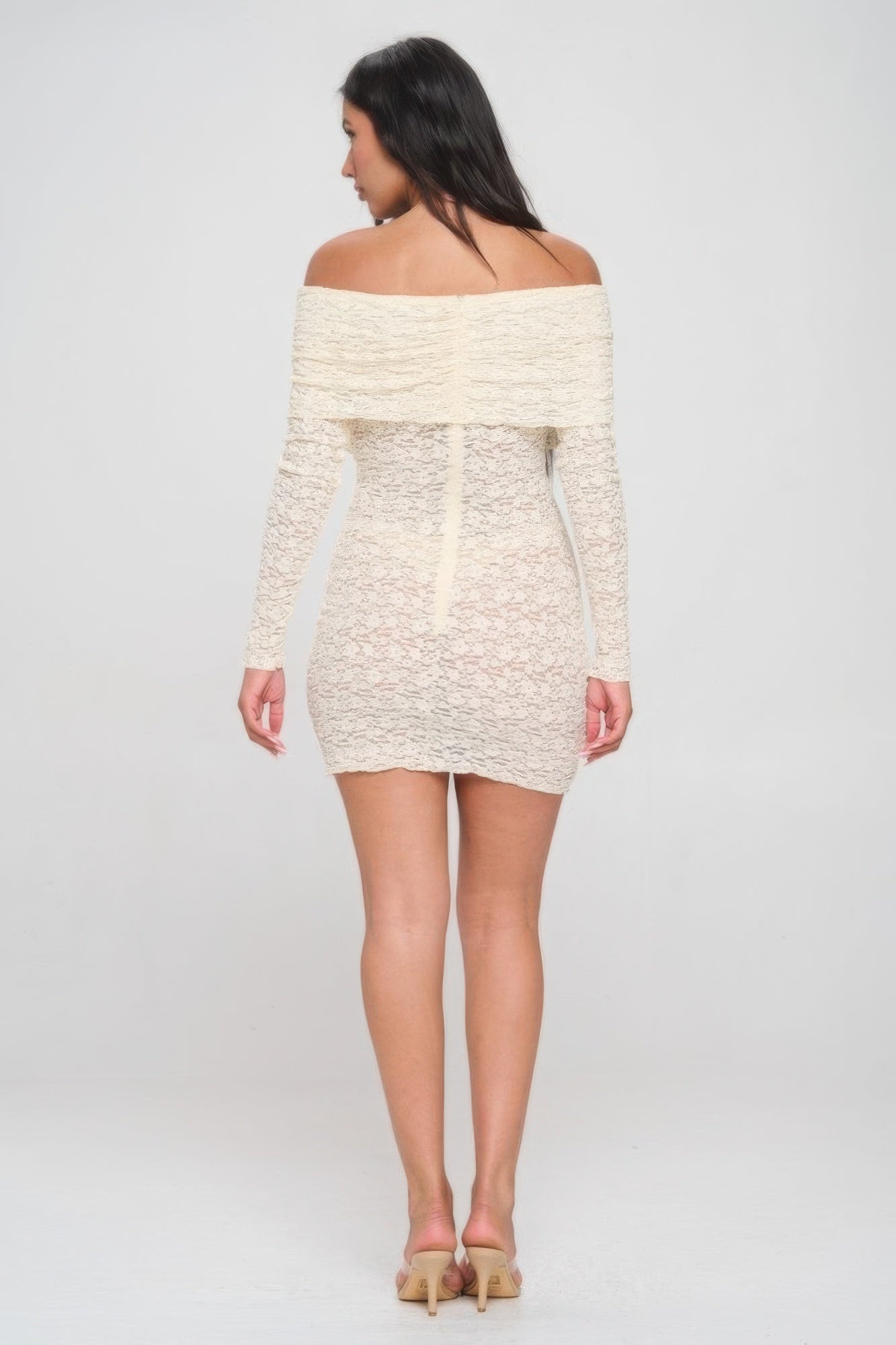 Back view of cream off-shoulder lace mini dress with long sleeves and fitted shape