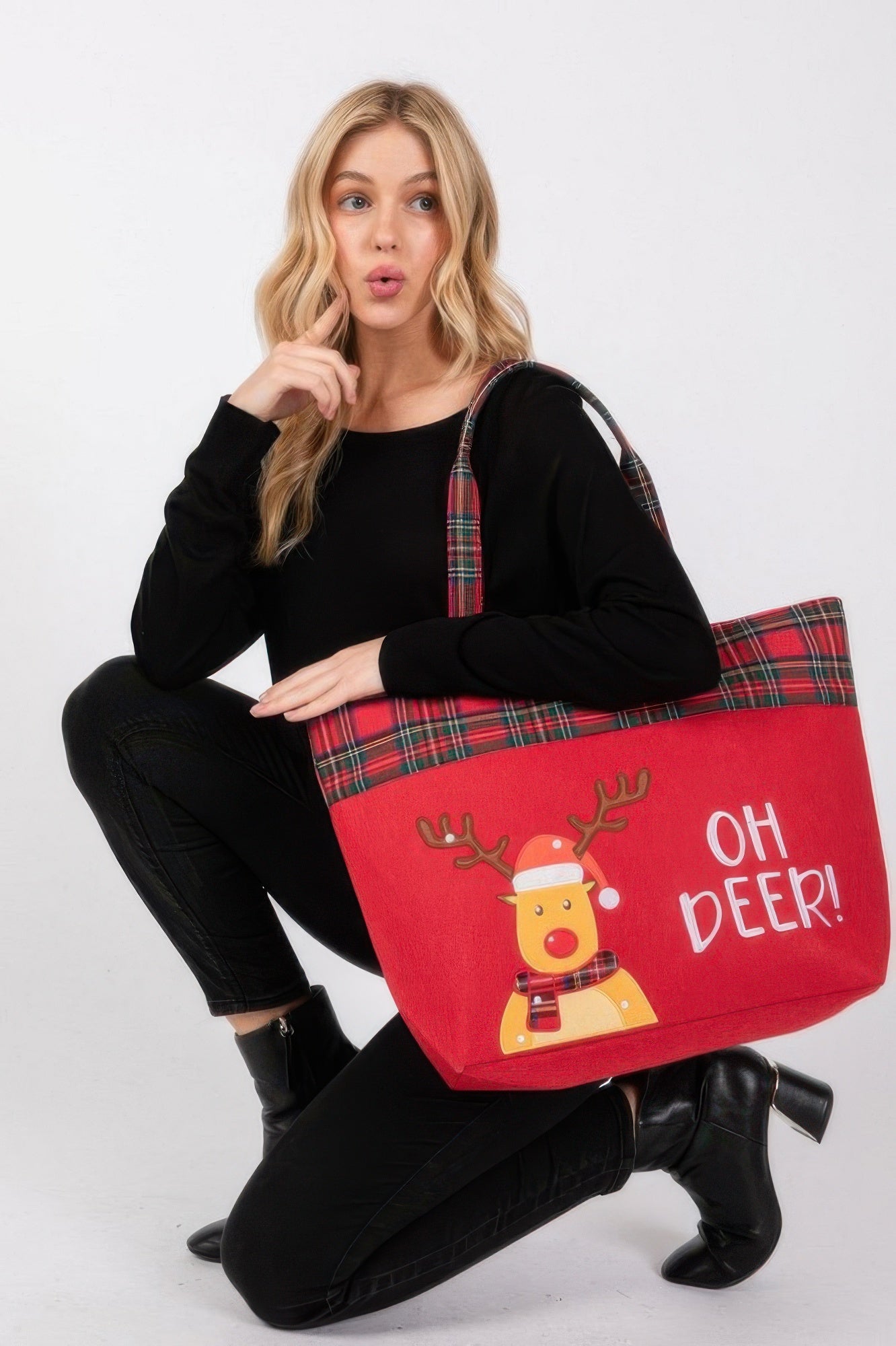 Oh Deer! tote bag held by model; red fabric with plaid handles and deer artwork