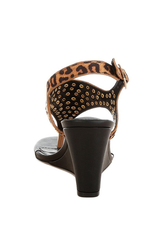 Back view of leopard wedge sandal with ankle strap and studded cutout panels