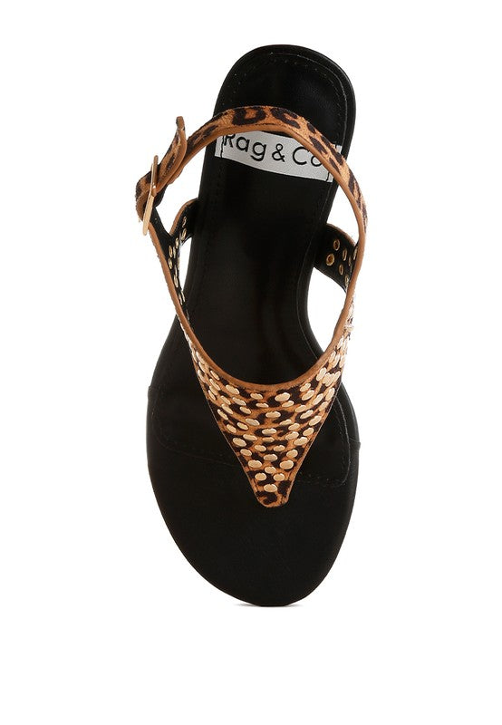 Side view of leopard wedge sandal with studded upper and open toe