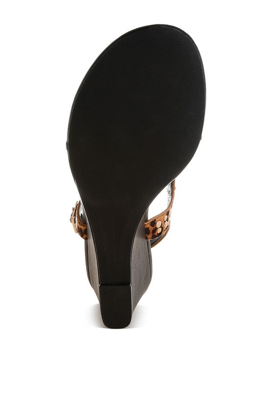 Heel view of leopard-print wedge sandal with textured black sole