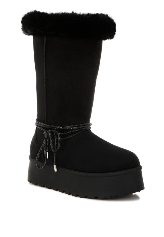 Black snow boots with faux fur top, lace tie strap, and chunky lug sole