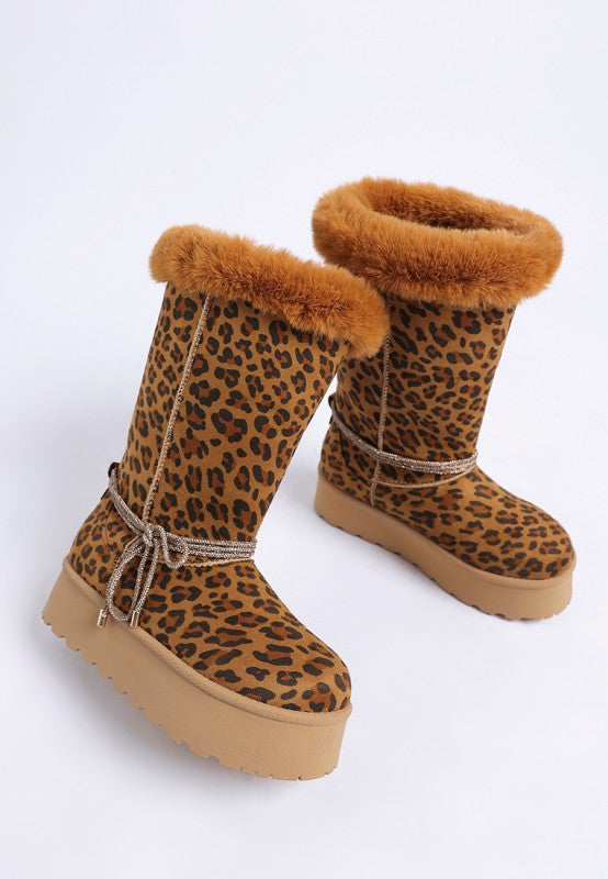 Leopard print snow boots with faux fur cuffs, lace tie strap, and tan lug sole