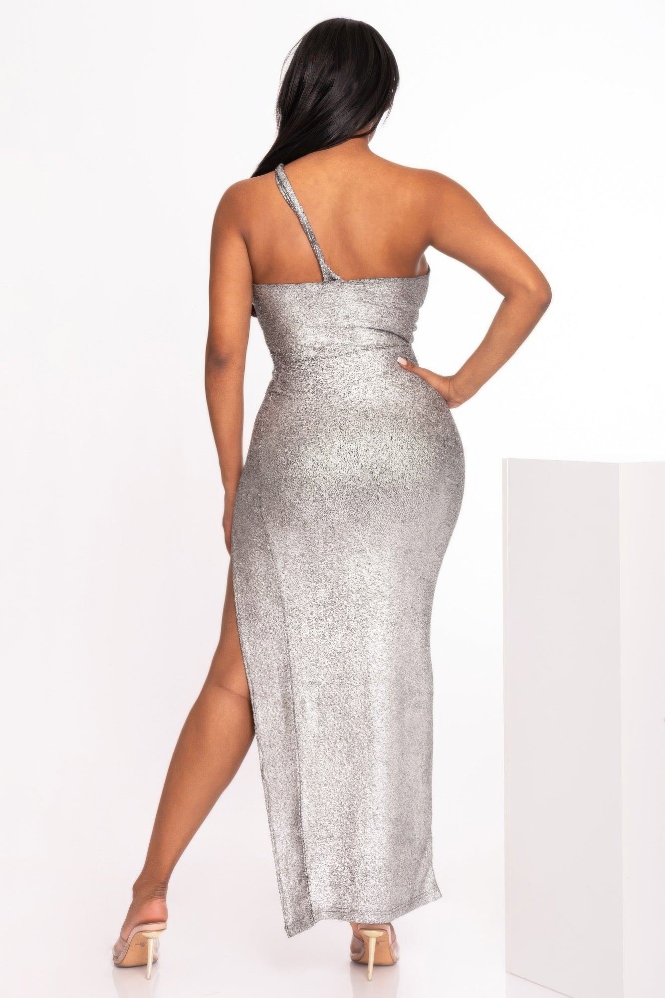 Back view: silver one-shoulder maxi dress with open back strap and side slit