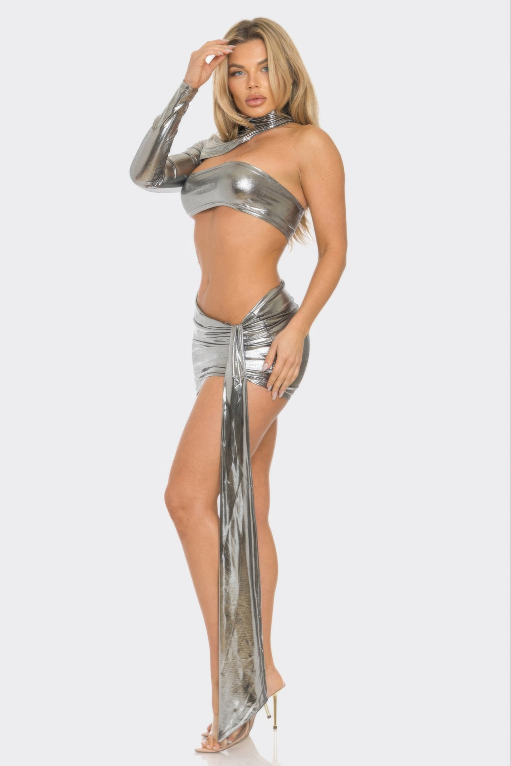Silver metallic bandeau crop top with one sleeve, ruched mini skirt and long slit drape