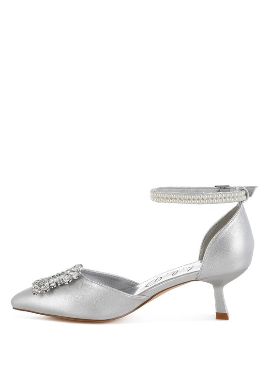 Silver kitten-heel sandal rear view with rhinestone accent and beaded ankle band
