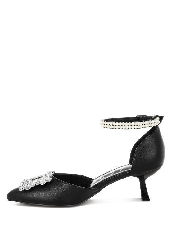 Black kitten heel slingback with pearl-trim band across the ankle and rhinestone toe