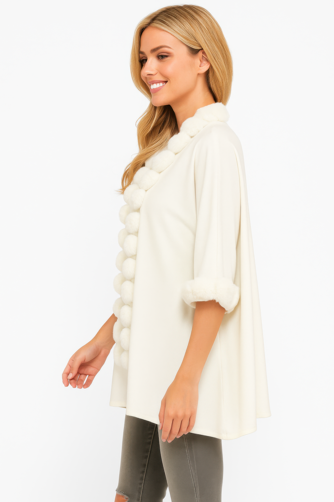 White open-front cape side view with pom faux fur trim and cuff pom accents