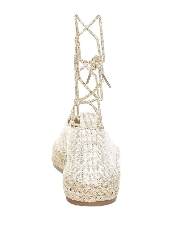 Gold canvas woven espadrille heel view with crisscross ankle laces and braided base
