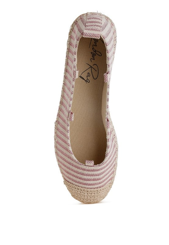 Pink striped espadrille shoe interior view with canvas lining and braided jute base