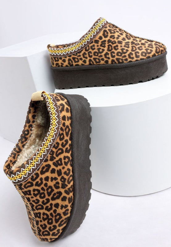 Leopard platform slip-on with round toe, stitched trim, and dark lug sole