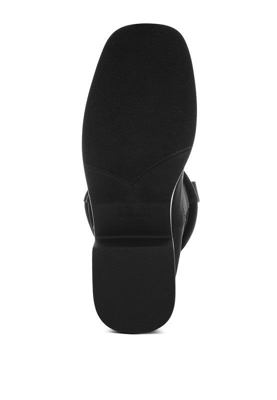 Black slouchy cowboy boot outsole view, textured rubber sole