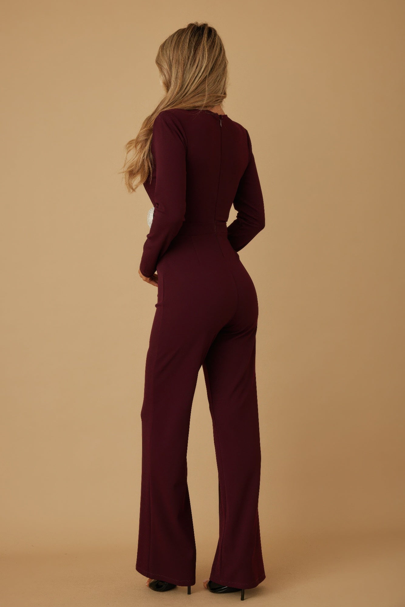 Wine wrap jumpsuit back view with fitted waist and long sleeves, wide flared legs.