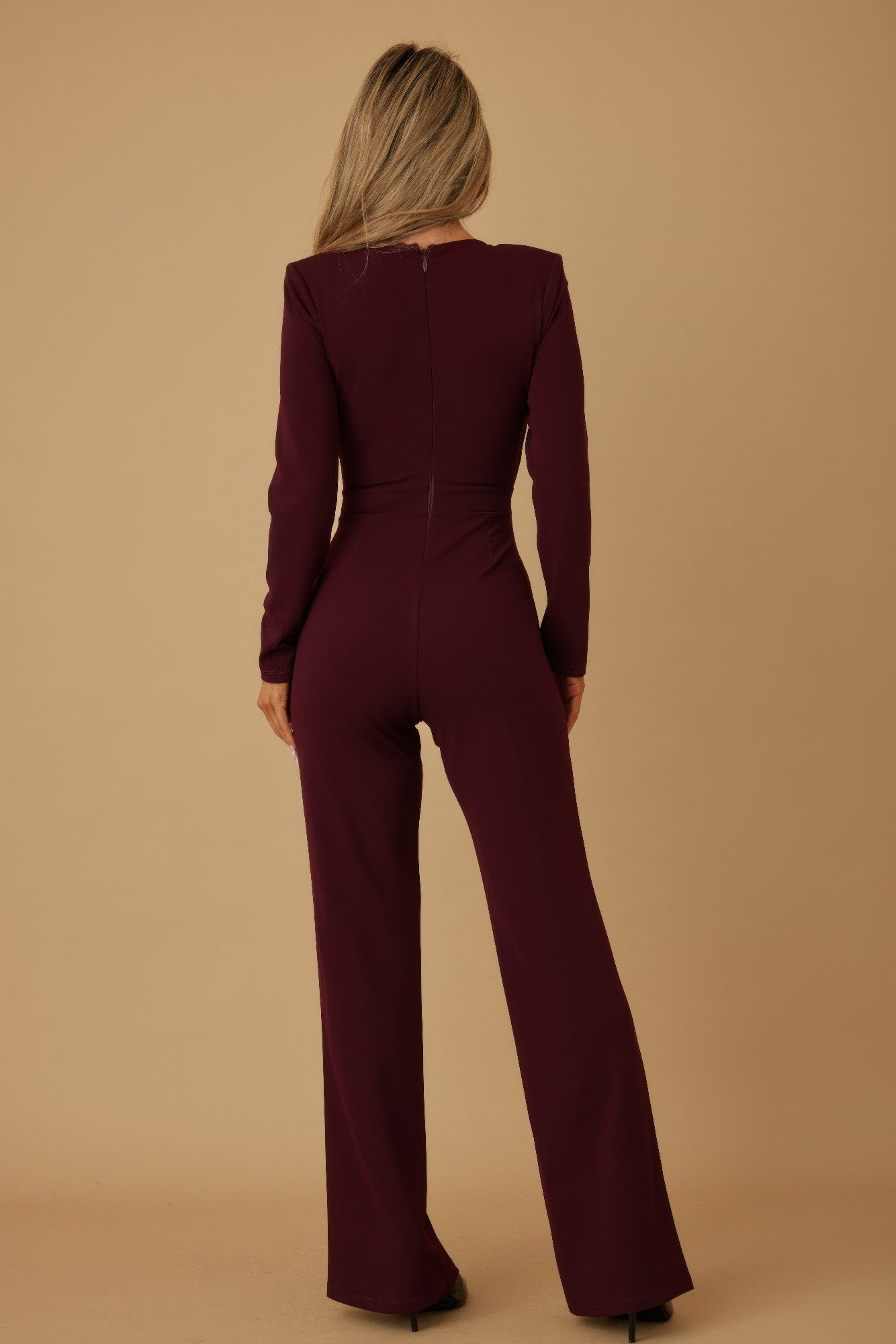 Wine wrap jumpsuit back view with straight back seam and wide-leg flare.