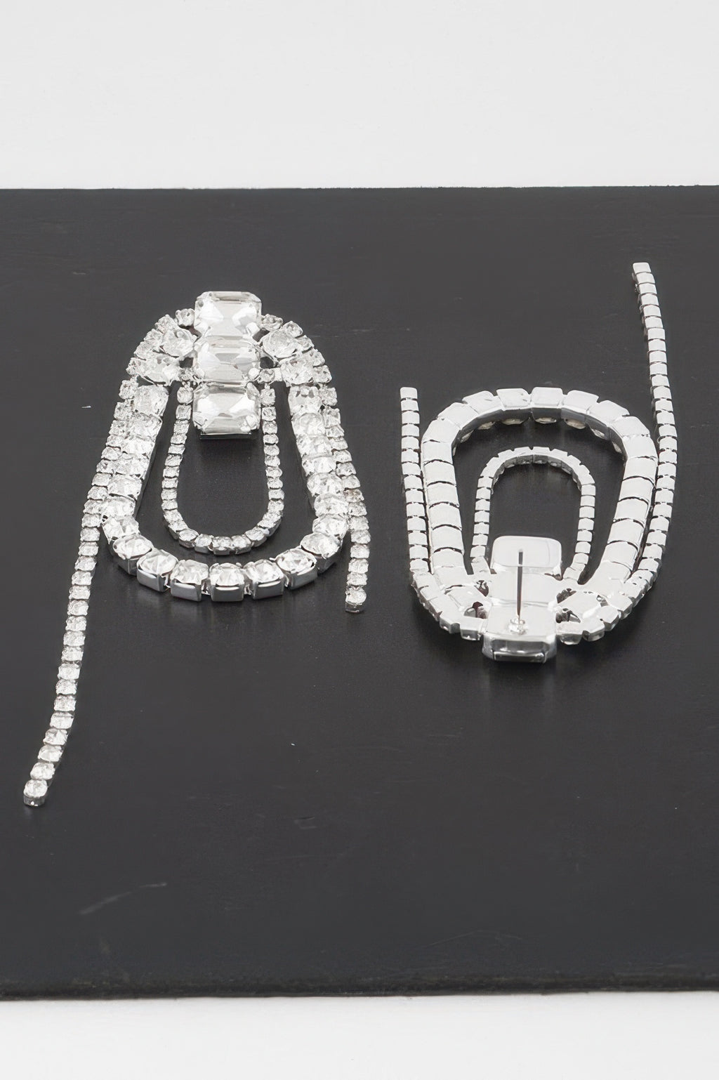 Oval rhinestone fringe earrings, prominent crystal center with dangling tassel strands