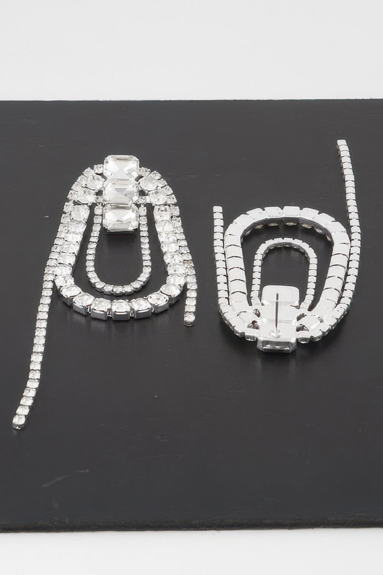 Oval rhinestone fringe earrings, prominent crystal center with dangling tassel strands