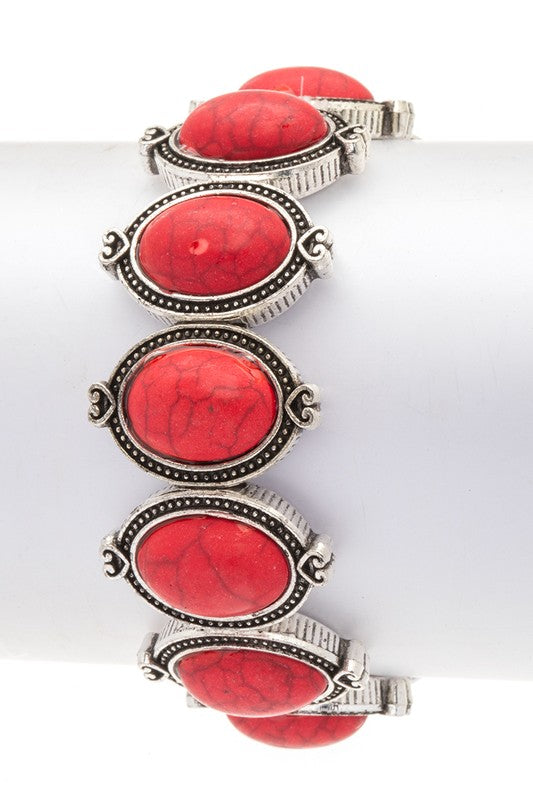 Oval stone western stretch bracelet, red cabochons on silver-toned segmented cuff