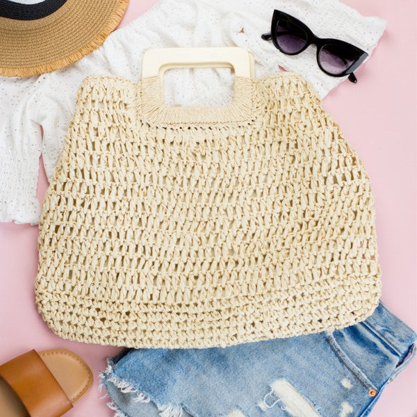 Close-up of khaki straw oversized tote with loop handle and textured woven rows