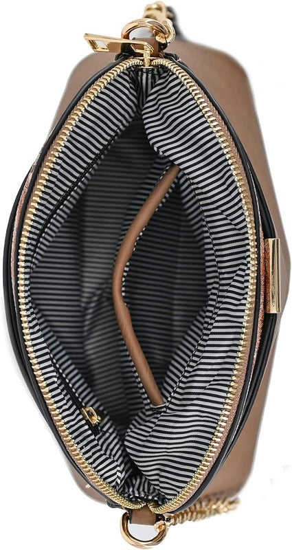 Small dome crossbody bag interior view with striped lining and gold zipper trim